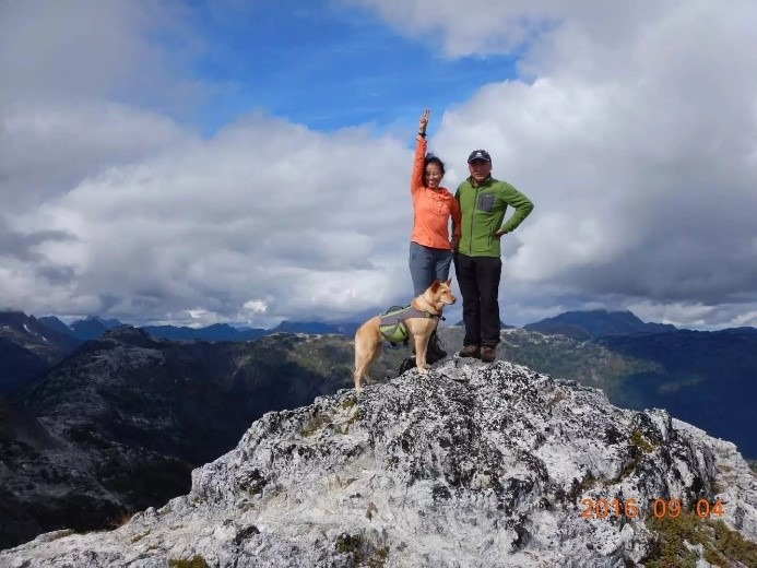 A person standing on top of a mountain
Description automatically generated, Picture